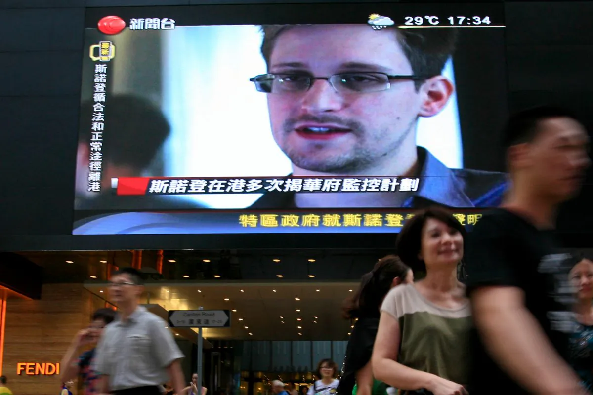 A TV screen shows a news report on Edward Snowden, a former CIA employee who leaked top-secret documents about U.S. surveillance programs, at a shopping mall in Hong Kong, June 23, 2013. Snowden was a hot potato in Hong Kong that the Chinese Communist Party has now palmed off, to the delight of Russia. (AP Photo/Vincent Yu)