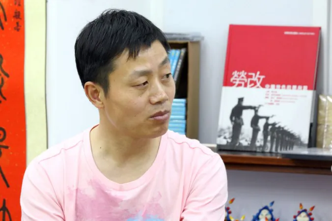 Du Bin on April 27 at a book store in Hong Kong, for the first public screening of his documentary "Women Above Ghosts' Heads." Du was recently released and escorted home by police. (Pan Zaishu/The Epoch Times)