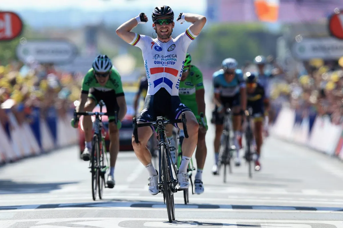 Mark Cavendish of Omega Pharma-Quick Step celebrates as he crosses the finish line to win Stage 13 of the 2013 Tour de France, a 173-km road stage from Tours to Saint-Amand-Montrond on July 12, 2013. (Doug Pensinger/Getty Images)