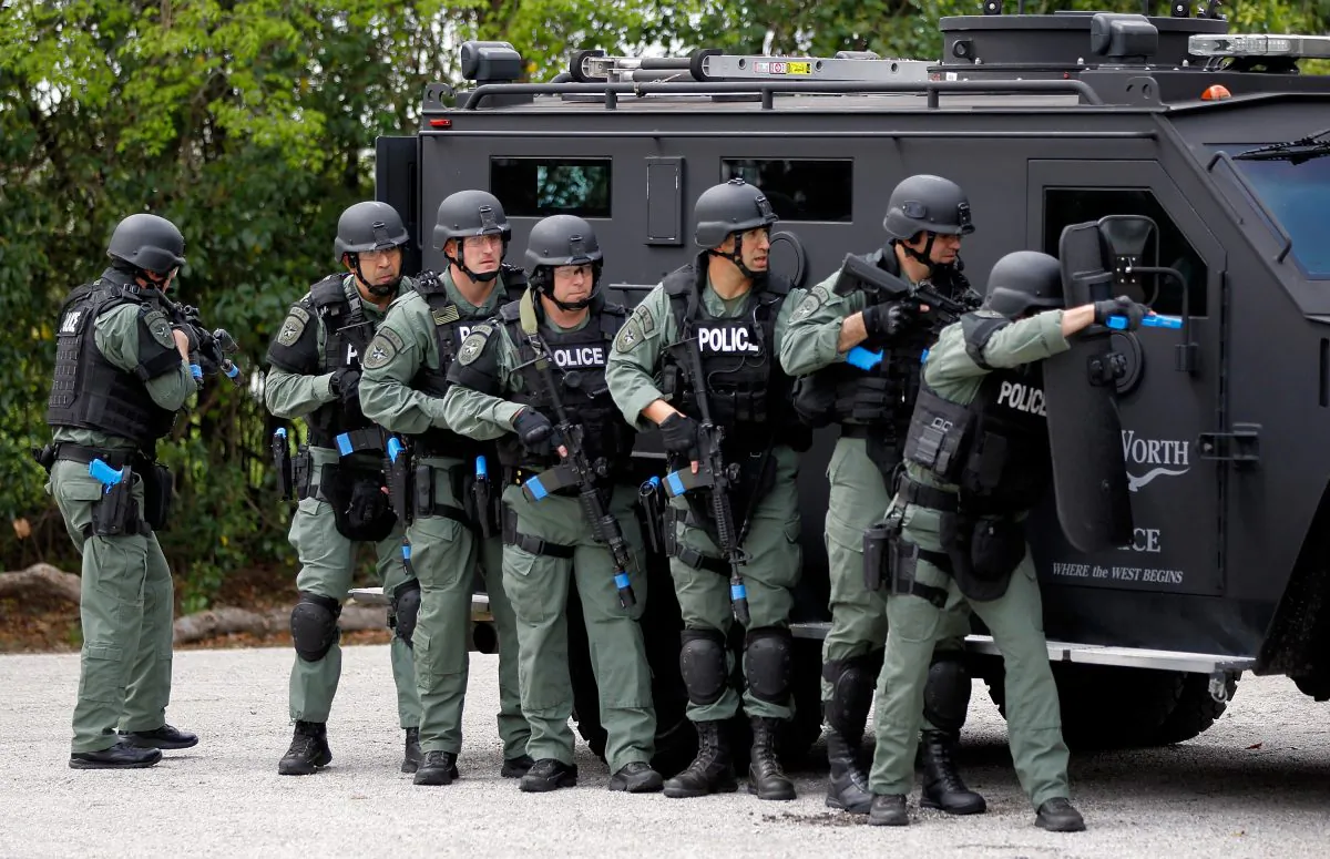 Fort Worth police department S.W.A.T. team members train with NASCAR driver Carl Edwards on March 21, 2012 in Fort Worth, Texas. Author Radley Balko says the trend to militarize police is dangerous and wrong. (Tom Pennington/Getty Images for Texas Motor Speedway)