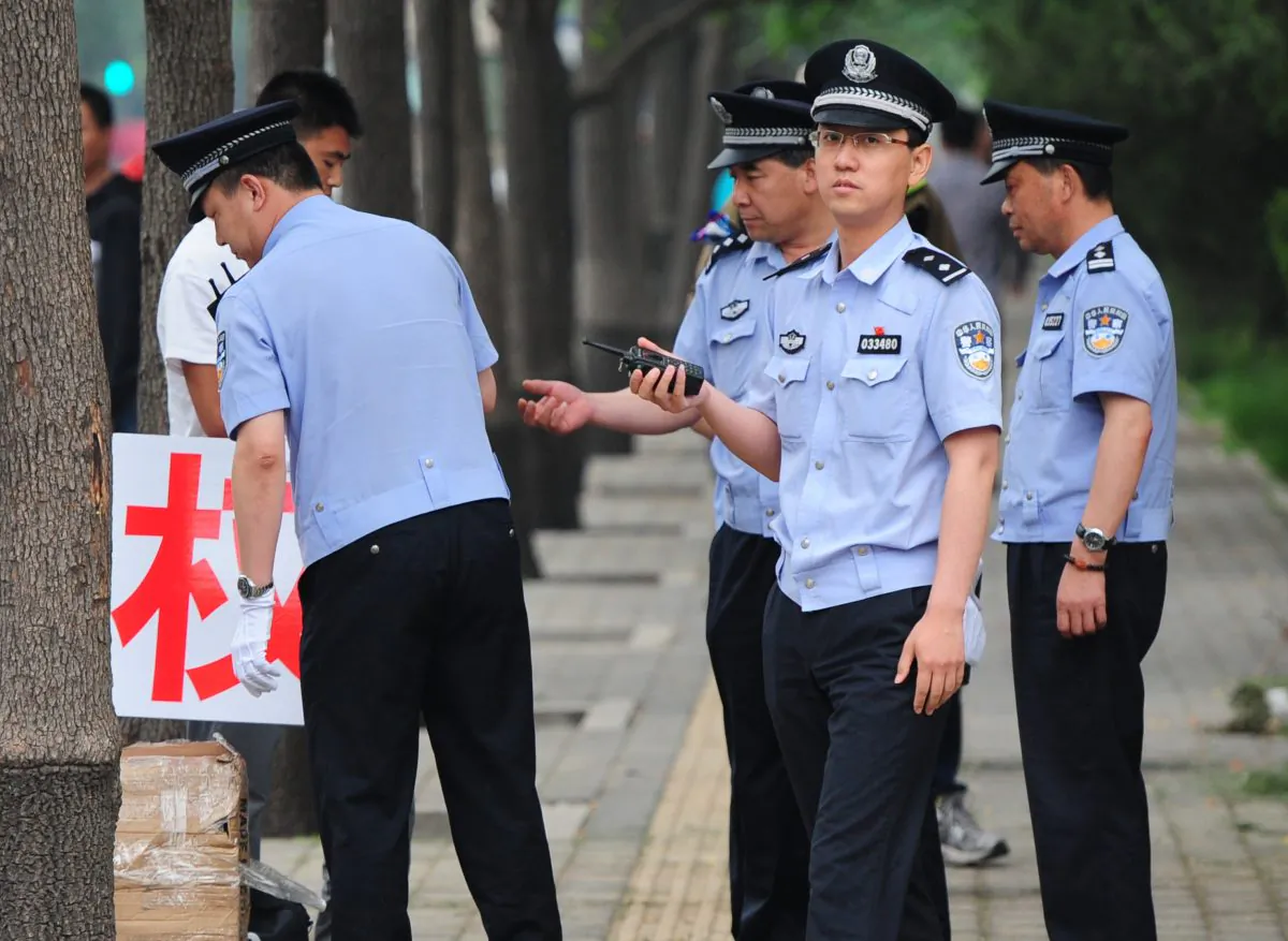 This file photo shows police in Beijing on May 11, 2012. A Bejing resident claims Beijing police framed, detained, and tortured her husband, eventually causing his wrongful death. (Mark Ralston/AFP/GettyImages)