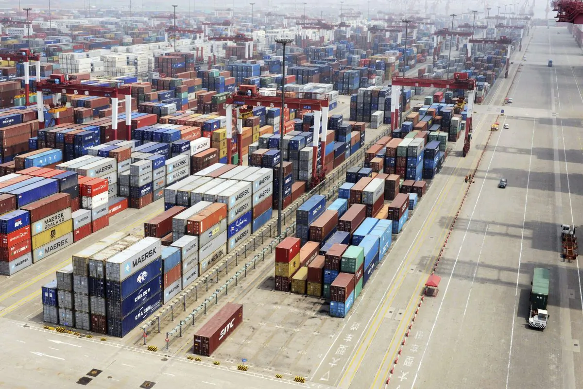 Containers are piled at a port in Qingdao in eastern China's Shandong Province on July 10, 2013. China reported Wednesday, July 10, 2013 that imports and exports both fell abruptly in June. The statistics are a new sign of weakness in the world's second-largest economy. (AP Photo)