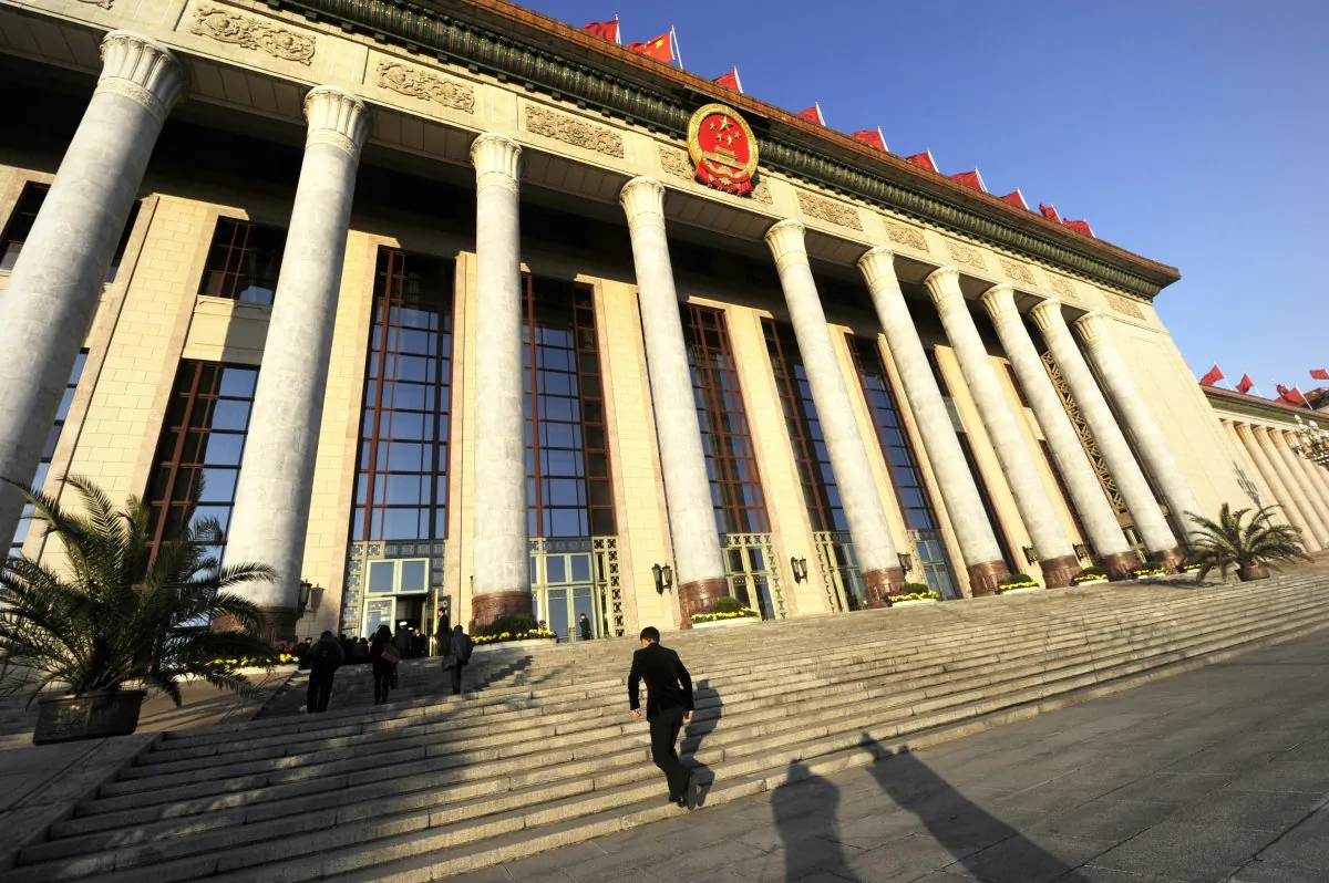 A security guard walks up steps into the Great Hall of the People before the closing of the 18th Communist Party Congress in Beijing on 14 Nov. 2012. The central government has ordered a nationwide audit of local government debt. (Wang Zhao/AFP/Getty Images)
