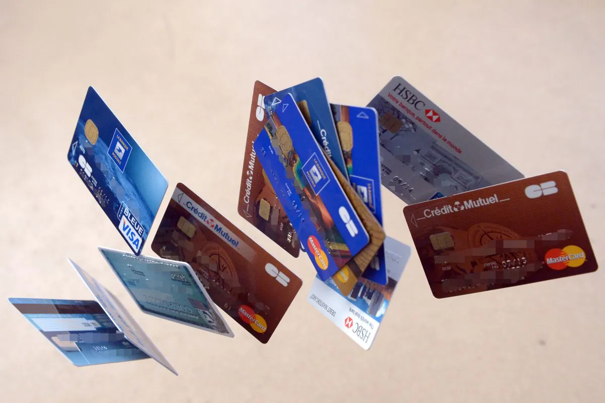 Payment cards falling down are pictured in this photo montage. In the United States, pre-paid debit cards are becoming ever more popular, but they carry certain drawbacks. (Damien Meyer/AFP/Getty Images)