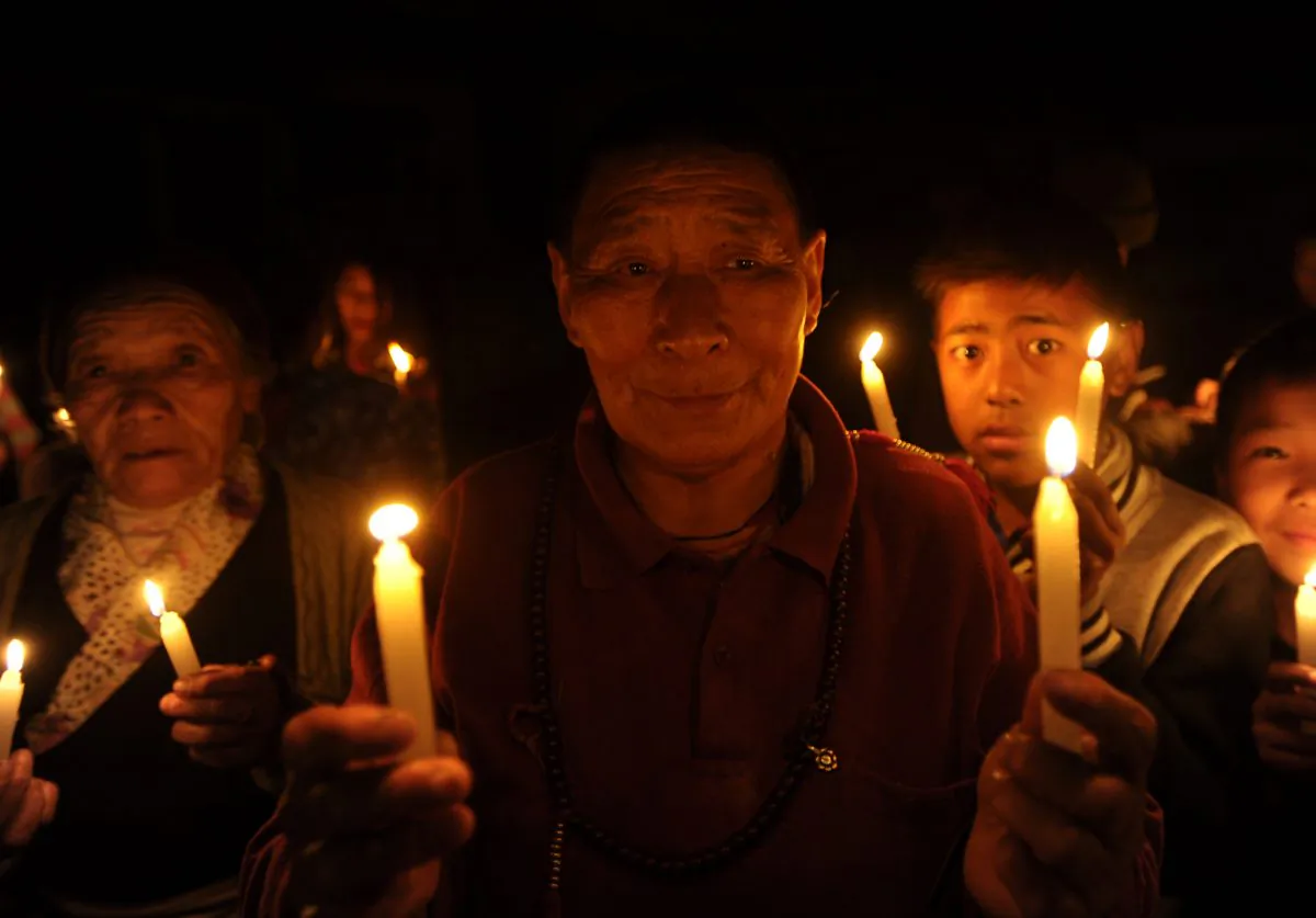 Tibetans-in-exile take part in a candlelight vigil in Kathmandu, India, on Feb. 13, 2013. A Chinese official has told a German news magazine that he will publish a book about the Party's policies in Tibet. (Prakash Mathema/AFP/Getty Images)