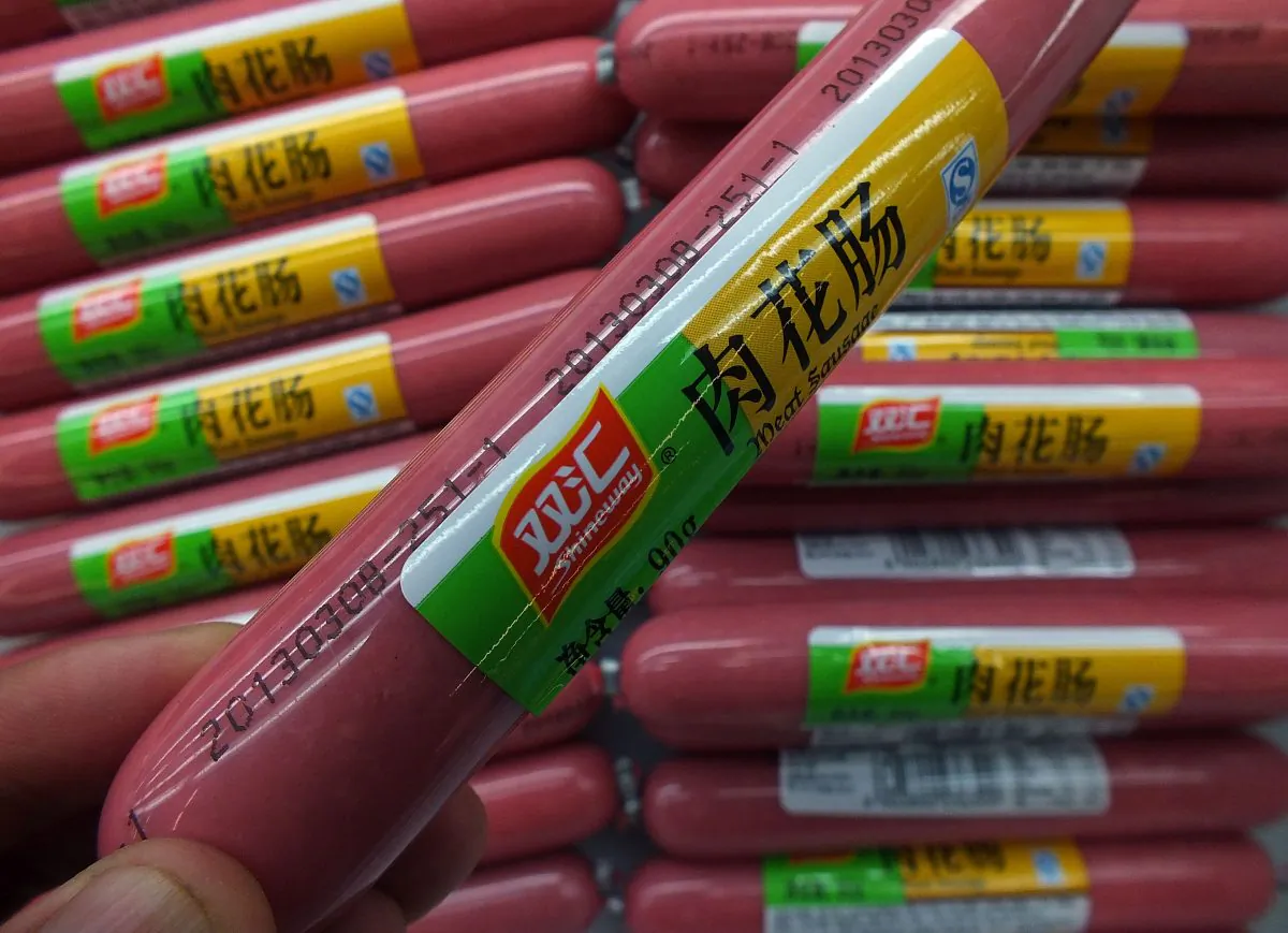 A customer selects a ham sausage, supplied by Shuanghui, which controls China's largest meat-processing company. Shuanghui is now looking to buy U.S. pork giant Smithfield Foods, but critics say a Chinese owner will hurt its reputation. (STR/AFP/Getty Images)