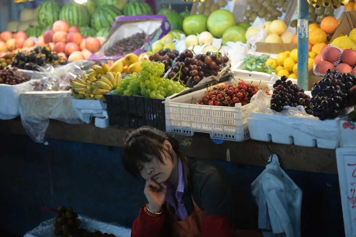 A fruit vendor takes a nap at a market in Shanghai on June 9, 2013. (Peter Parks/AFP/Getty Images)