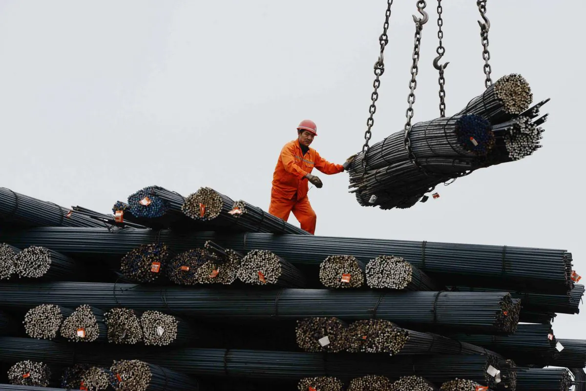 A laborer works in a steel factory in Qingdao, in eastern China’s Shandong Province, on June 15, 2013. In 2011, China’s economy operated at 60 percent of its productive capacity, and the steel industry, along with several other major industries, was plagued by overcapacity. (STR/AFP/Getty Images)