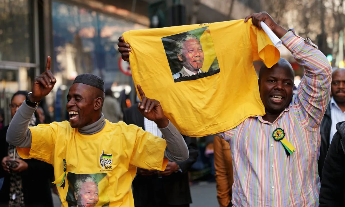People pray and sing songs of support for former South African President Nelson Mandela during an African National Congress-sponsored prayer rally outside ANC headquarters July 2, 2013, in Johannesburg, South Africa. Americans tend to connect Nelson Mandela with Martin Luther King, but according to one historian, Mandela has more in common with George Washington. (Chip Somodevilla/Getty Images)
