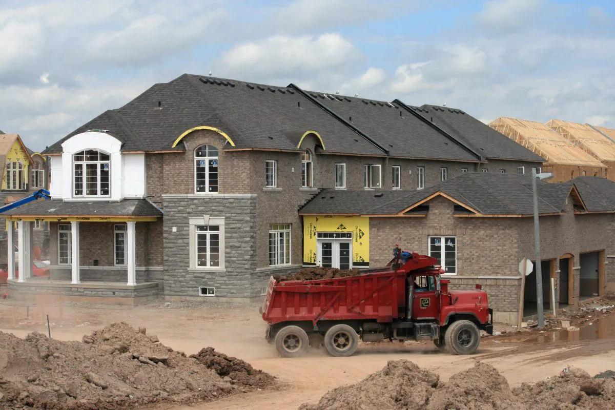 A truck gets set to dump clean fill at a new housing development in Oakville, Ont., in this file photo. A few recent data releases bode well for Canada’s housing market for the next year and a half. (The Canadian Press/Richard Buchan)