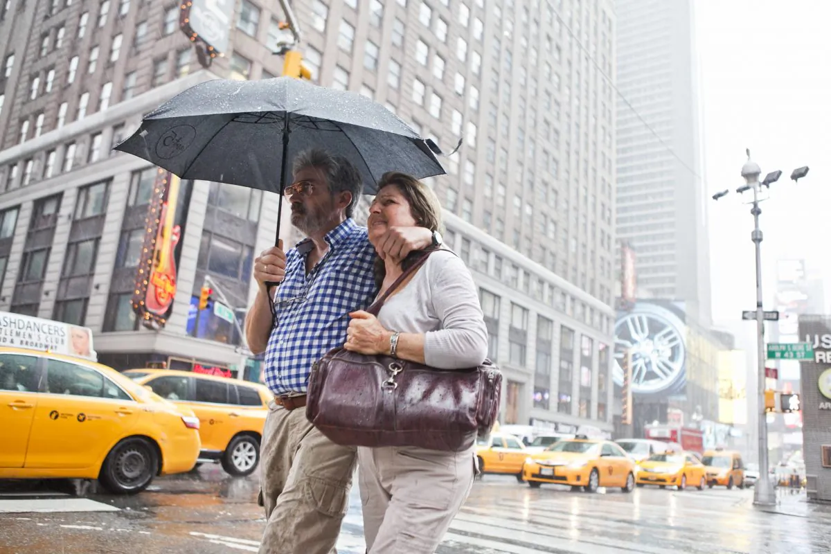 People at Times Square on July 1. The National Weather Service issued a flash flood warning for parts of New York and New Jersey. (Samira Bouaou/Epoch Times)