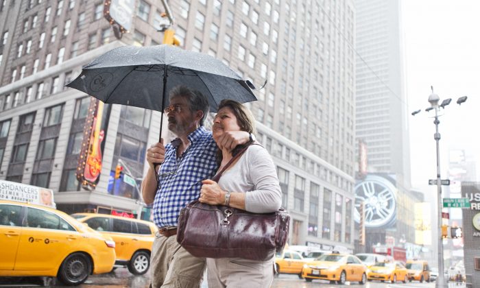 People at Times Square on July 1. The National Weather Service issued a flash flood warning for parts of New York and New Jersey. (Samira Bouaou/Epoch Times)