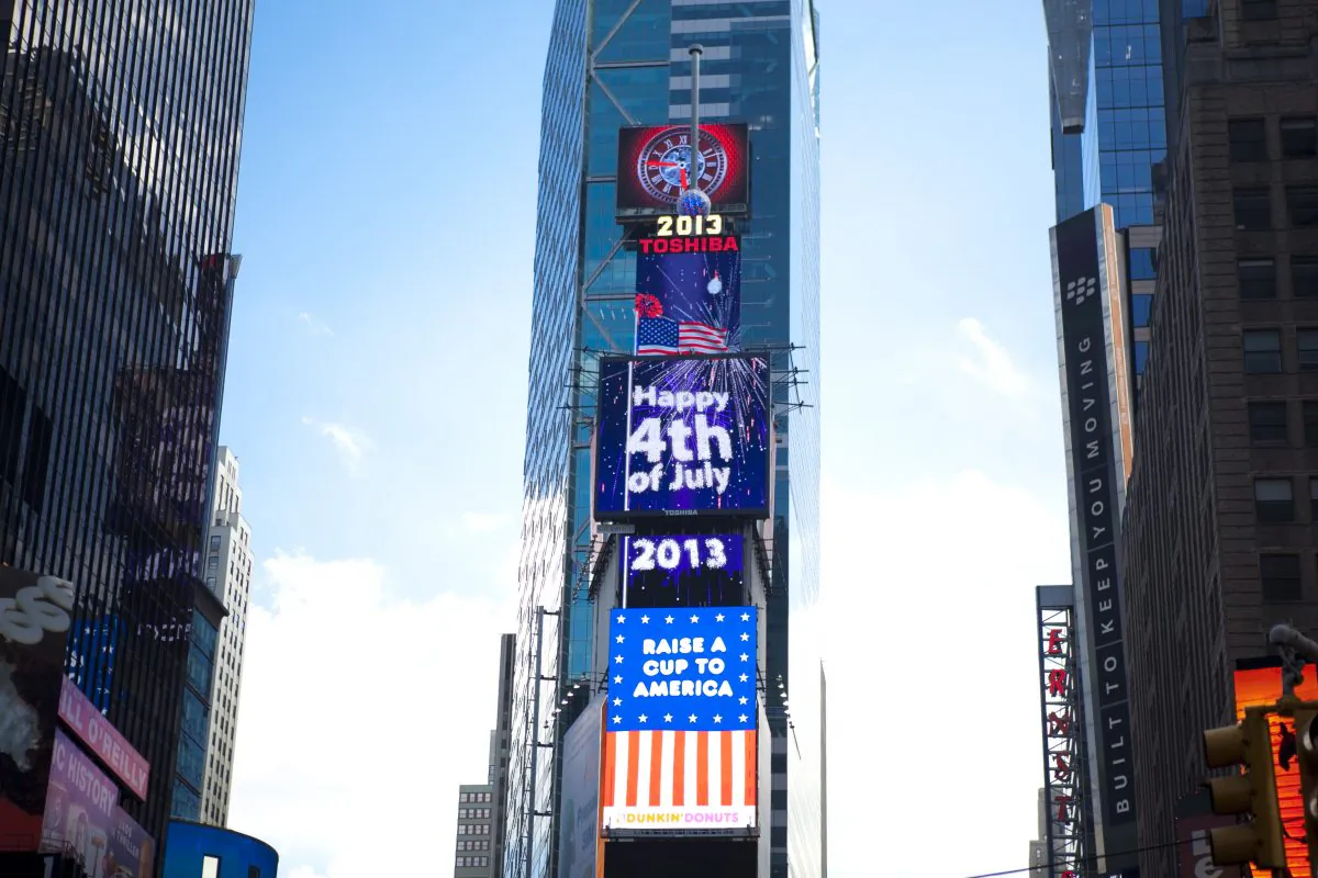A billboard in Times Square displays Happy July 4th with fireworks messages. (Samira Bouaou/Epoch Times)