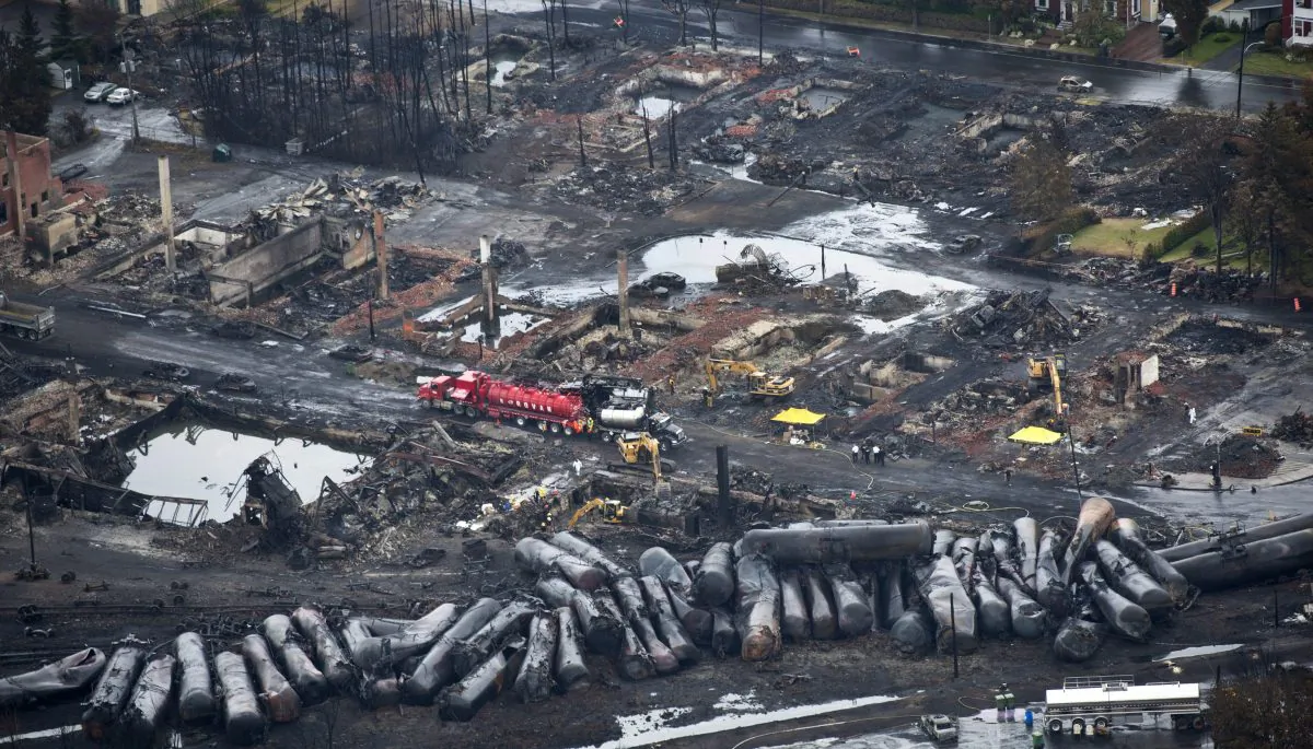 Workers comb through debris on July 9 after a run away oil train derailed July 6, 2013 causing explosions, fire and destroying parts of Lac-Megantic, Quebec. (AP Photo/The Canadian Press, Paul Chiasson)