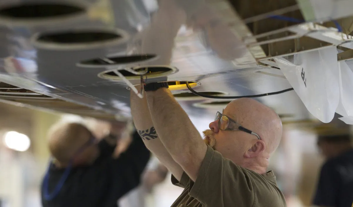 A Boeing employee works on a Boeing 777 jet wing June 13, 2012 at the Boeing Factory in Everett, Washington. Boeing is facing a $2.75 million fine over installing bad fasteners on the 777. (Stephen Brashear/Getty Images)