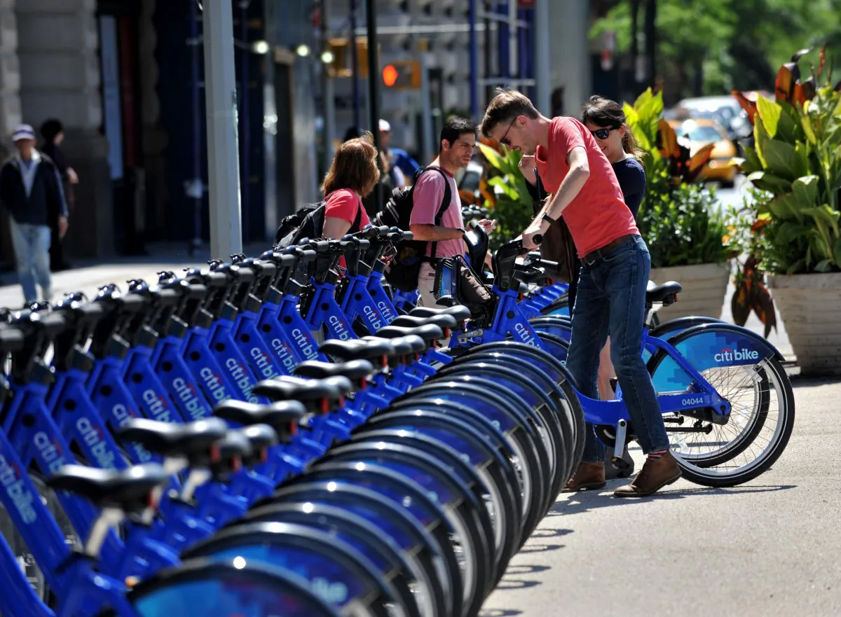 A couple get their Citi Bike bicycles from a station near Union Square as the bike sharing system is launched May 27 in New York. (STAN HONDA/AFP/Getty Images)