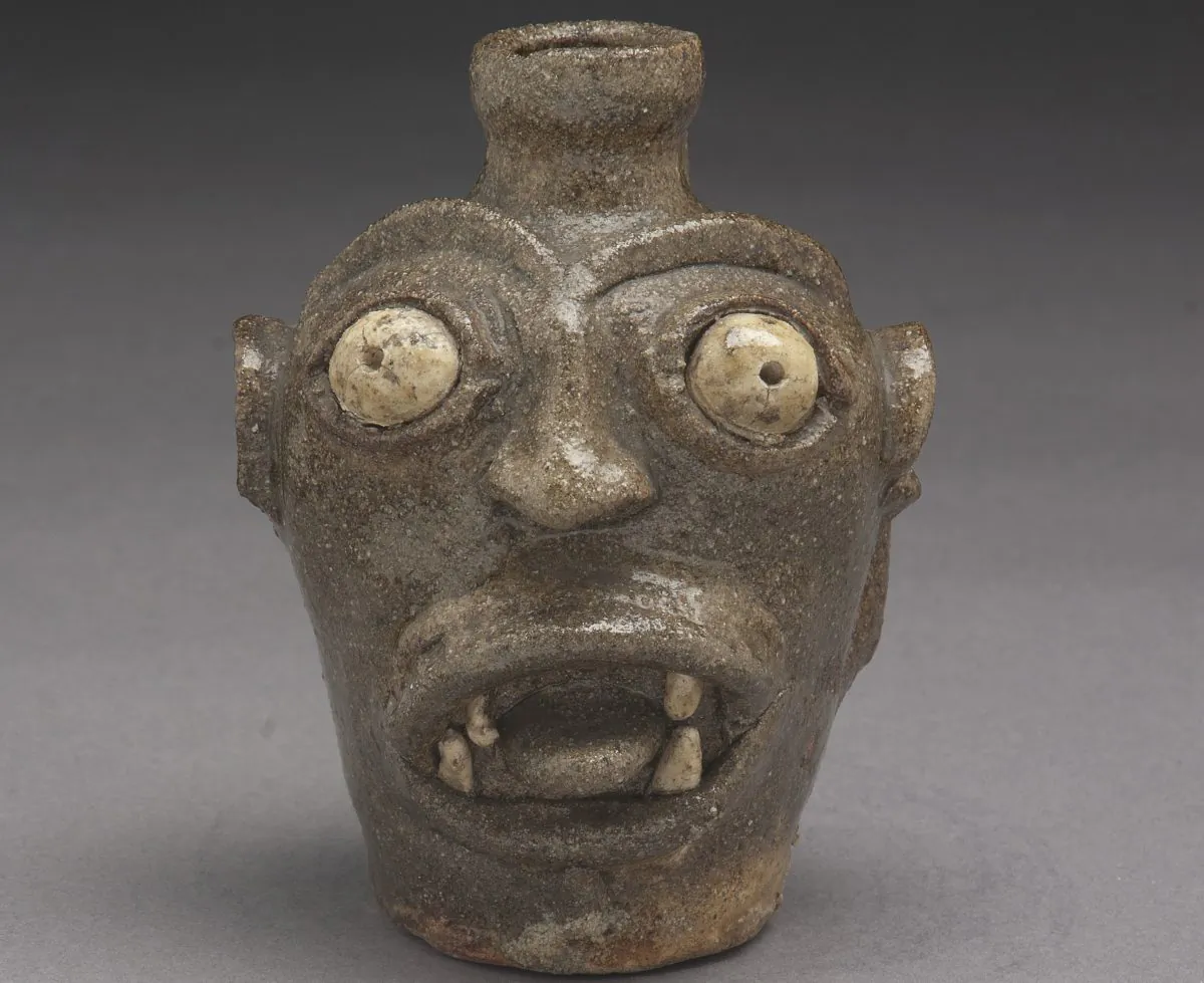 A small stoneware jug, unique among Edgefield face jugs, roars its defiance in the face of slavery. Such art preserved Kongo religious and spiritual beliefs in a coded form beyond the understanding of white Southern planters. (Courtesy The Chipstone Foundation)