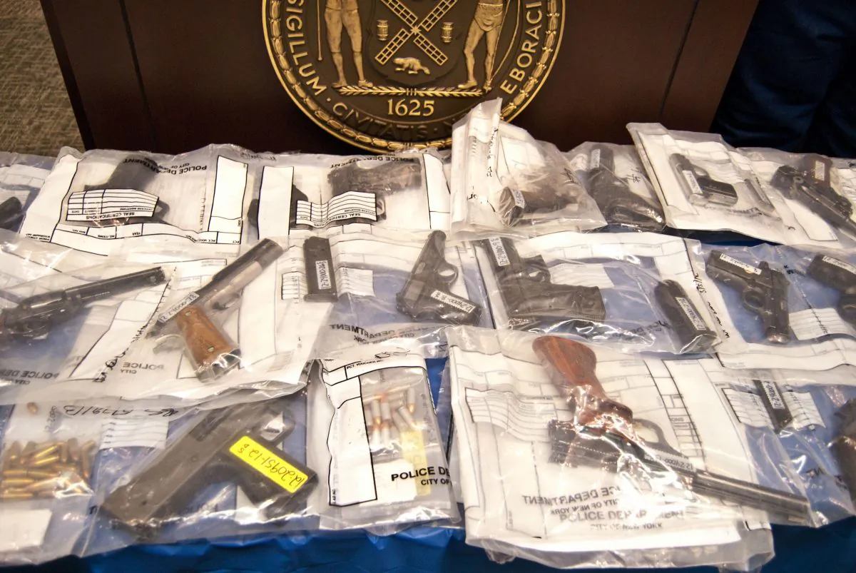Guns belonging to the Bonanno crime family, one of the five main families of the Italian Mafia, are presented as evidence on July 9. (Joshua Philipp/The Epoch Times)