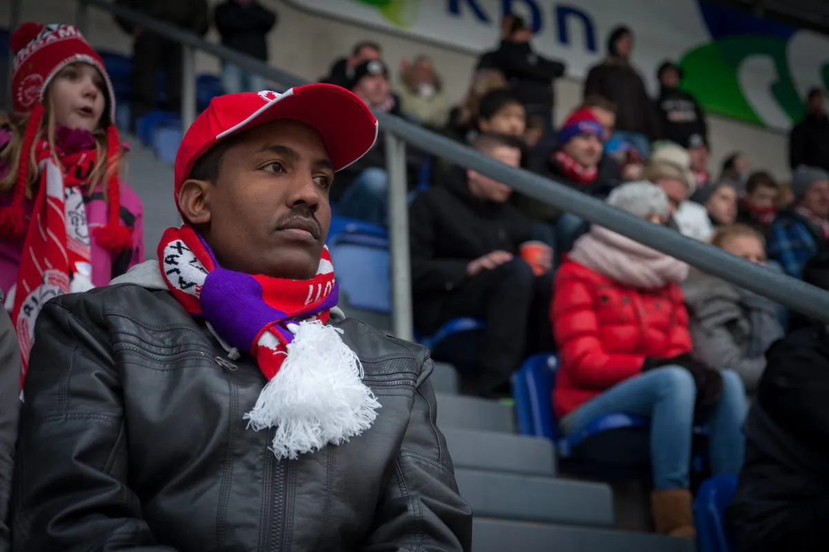 Refugee Fasil Agegnehu watches a soccer game in Amsterdam, Netherlands. Agegnehu is one of four refugees featured in the documentary "Refugees: Who Needs Them?" showing an increasingly anti-immigrant climate in the Netherlands. (Courtesy of Miles Roston)