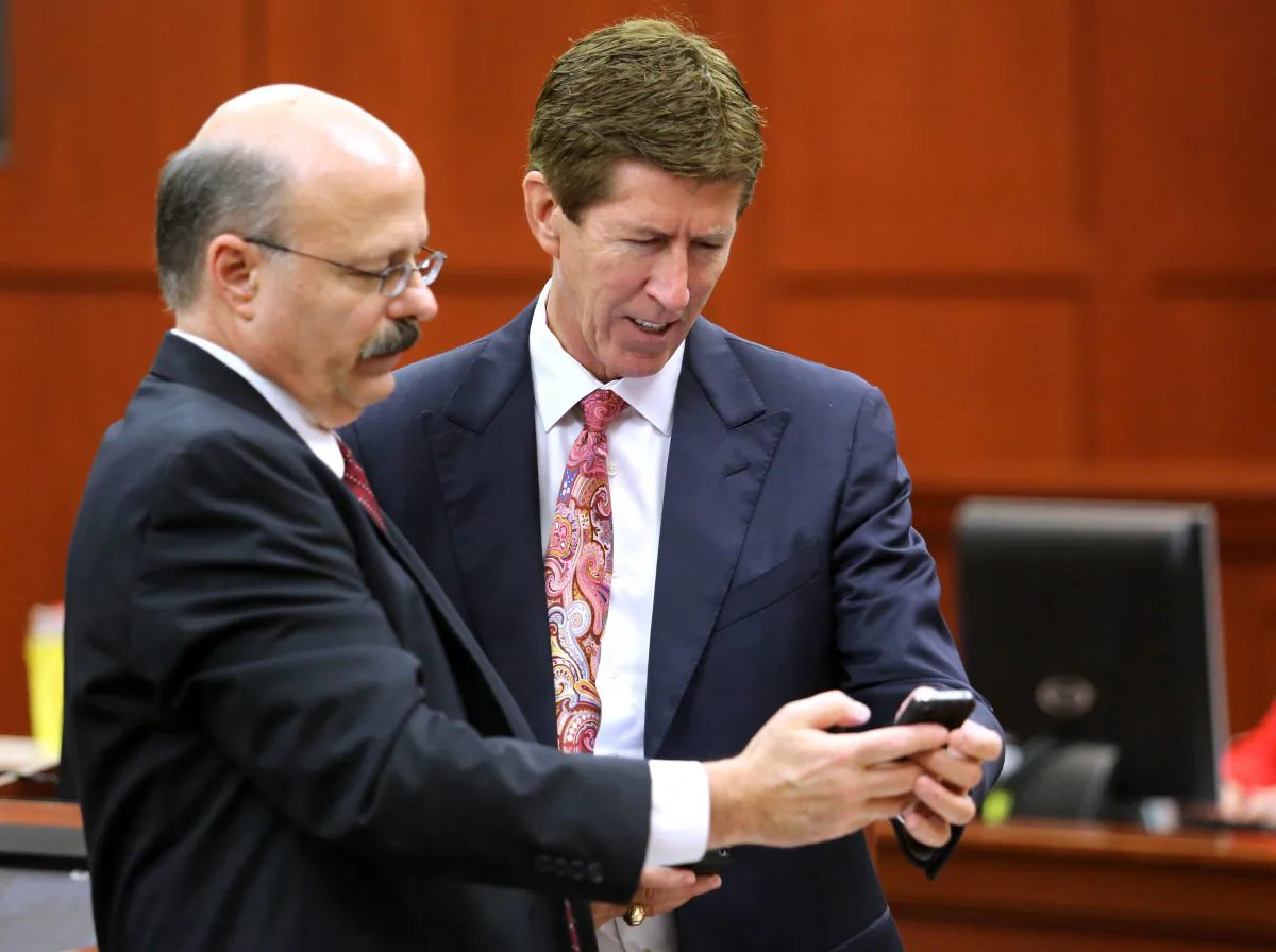 Prosecutor Bernie de la Rionda, left, and defense attorney Mark O'Mara confer during the 15th day of the George Zimmerman trial in Seminole circuit court, in Sanford, Fla., Friday, June 28, 2013. Zimmerman has been charged with second-degree murder for the 2012 shooting death of Trayvon Martin.(AP Photo/Orlando Sentinel, Joe Burbank, Pool)