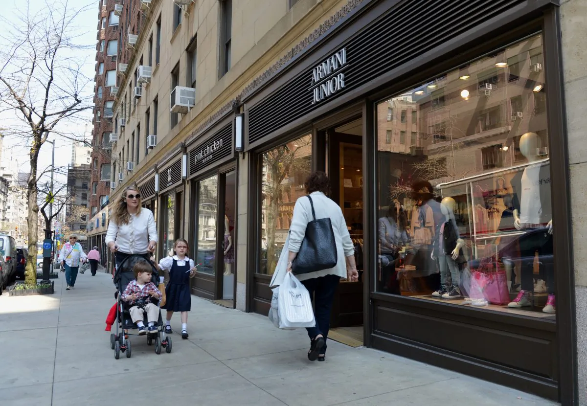 People pass by storefronts on Madison Avenue on the Upper East Side of Manhattan April 10 in New York. A recent survey from the Siena Research Institute found that consumer trust is rising in New York City. (STAN HONDA/AFP/Getty Images) 