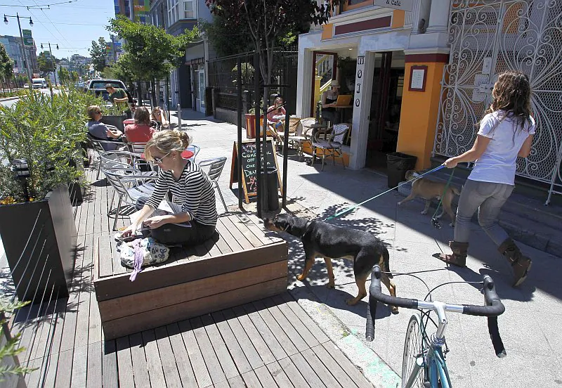 People enjoy the sun at a parklet on Divisadero Street in San Francisco, June 11, 2010.
(AP Photo/Eric Risberg) 