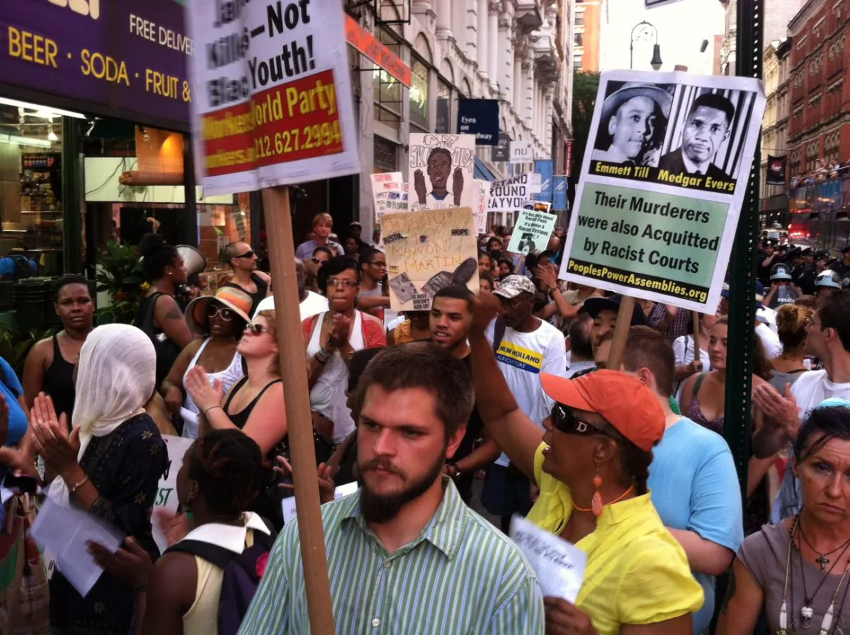 A crowd of about 300 protesters, surrounded by NYPD officers, walk through New York City streets in Lower Manhattan on Monday, July 15, 2013. (Genevieve Belmaker/Epoch Times)