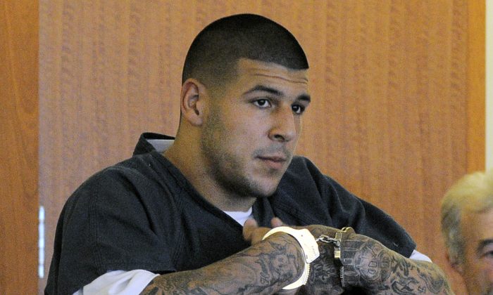 Former New England Patriots football tight end Aaron Hernandez stands during a bail hearing in Fall River Superior Court Thursday, June 27, 2013 in Fall River, Mass. Hernandez, charged with murdering Odin Lloyd, a 27-year-old semi-pro football player, was denied bail. (AP Photo/Boston Herald, Ted Fitzgerald, Pool)