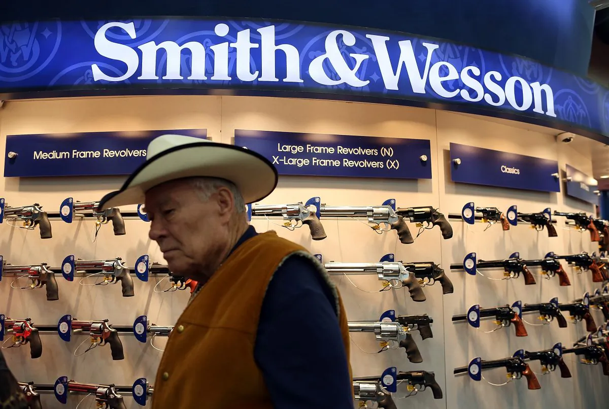 An attendee walks through the Smith and Wesson booth during the 2013 NRA Annual Meeting and Exhibits at the George R. Brown Convention Center in Houston, Texas, on May 3, 2013. New York Public Advocate Bill de Blasio announced July 22 that eight hedge funds and money managers have divested gun holdings valued at $150 million. (Justin Sullivan/Getty Images)