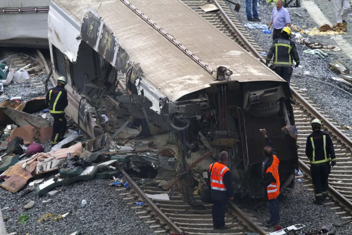 Rail personnel and firefighters inspect the derailed cars at the site of a train accident in Santiago de Compostela, Spain, on Thursday, July 25, 2013.  (AP Photo/ Lalo Villar)