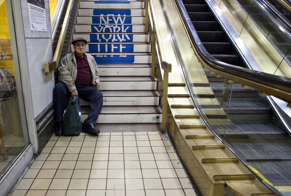 A man rests on stairs at the New York Port Authority bus terminal in Manhattan on November 21, 2012 in New York City. Mayor Michael Bloomberg said July 16 he plans to introduce legislation to City Council to make stairways more visible and easier to find in all new buildings. (Ramin Talaie/Getty Images)