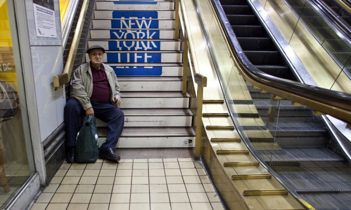A man rests on stairs at the New York Port Authority bus terminal in Manhattan on November 21, 2012 in New York City. Mayor Michael Bloomberg said July 16 he plans to introduce legislation to City Council to make stairways more visible and easier to find in all new buildings. (Ramin Talaie/Getty Images)
