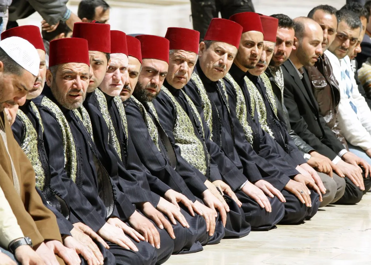 People pray in the Omayyad mosque courtyard on March 23, 2013 in the Syrian capital of Damascus, during the funeral ceremony of Sunni Muslim cleric Mohamed Saeed al-Bouti, who died in a suicide bomb attack. The suicide bomb attack in the mosque two days earlier killed 42 people. (Louai Beshara/AFP/Getty Images)