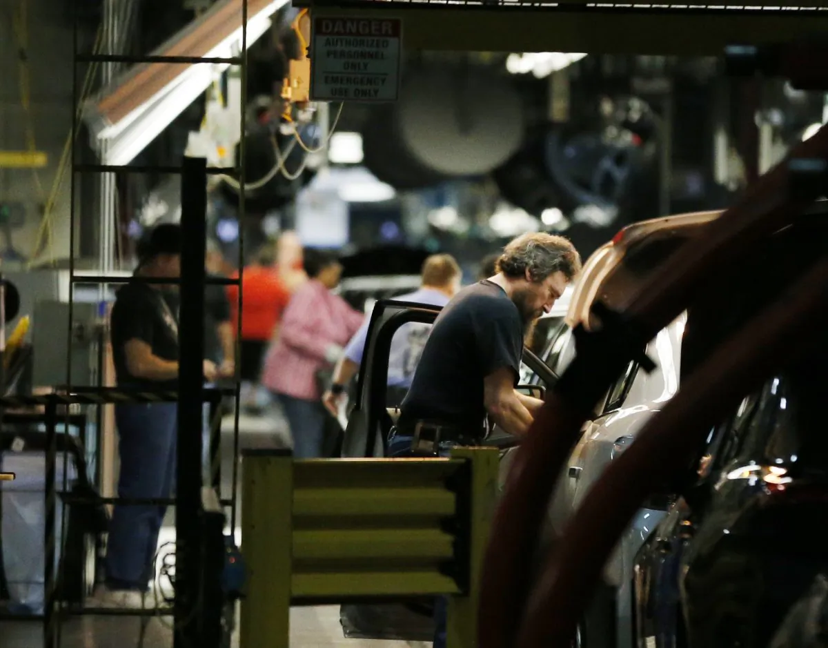 Workers assemble cars along a line at the General Motors Fairfax plant in Kansas City, Kan. (AP Photo / Orlin Wagner / File Photo)