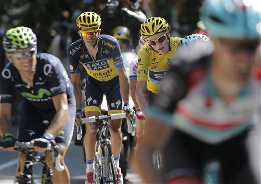 Spain's Alejandro Valverde, left, Spain's Alberto Contador, second left, and Christopher Froome of Britain, wearing the overall leader's yellow jersey, catch up with breakaway Jens Voigt of Germany, right, during the 20th stage of the Tour de France cycling race over 125 kilometers (78.1 miles) with start in in Annecy and finish in Annecy-Semnoz, France, Saturday July 20 2013. (AP Photo/Christophe Ena)