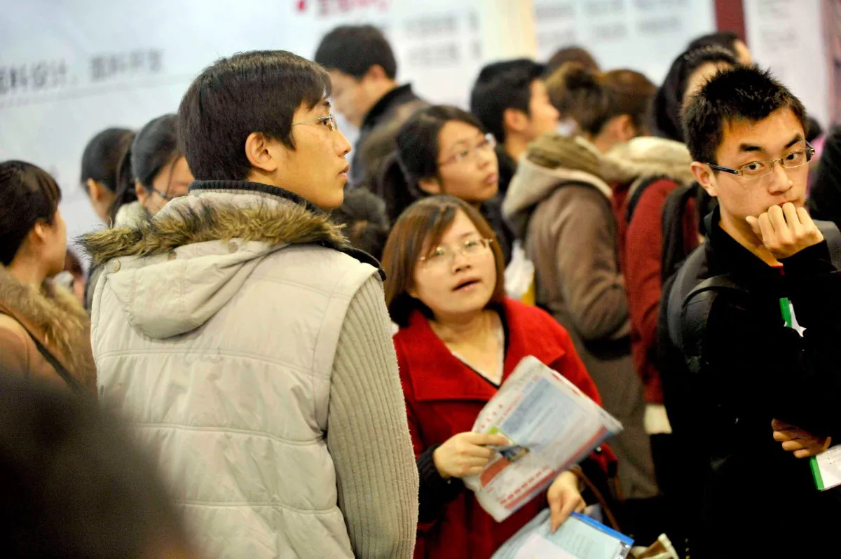 Jobseekers attend a job fair at the Hangzhou Peace International Exhibition and Conference Center in Hangzhou City, Zhejiang Province. As the Chinese economy slows, many foreign and domestic firms in China have begun laying off their employees, leaving many jobless. (ChinaFotoPress/Getty Images)