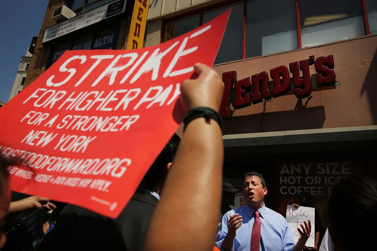 New York City Councilman Brad Lander speaks to employees at Wendy's fast-food restaurant during a demonstration demanding higher pay and the right to form a union on July 29, 2013 in New York City. Across the country thousands of low-wage workers are expected to walk off their jobs Monday at fast food establishments in seven U.S. cities. Workers at KFC, Wendy's, Burger King, McDonald's and other restaurants are calling for a living wage of $15 an hour and the right to form a union without retaliation. (Spencer Platt/Getty Images)