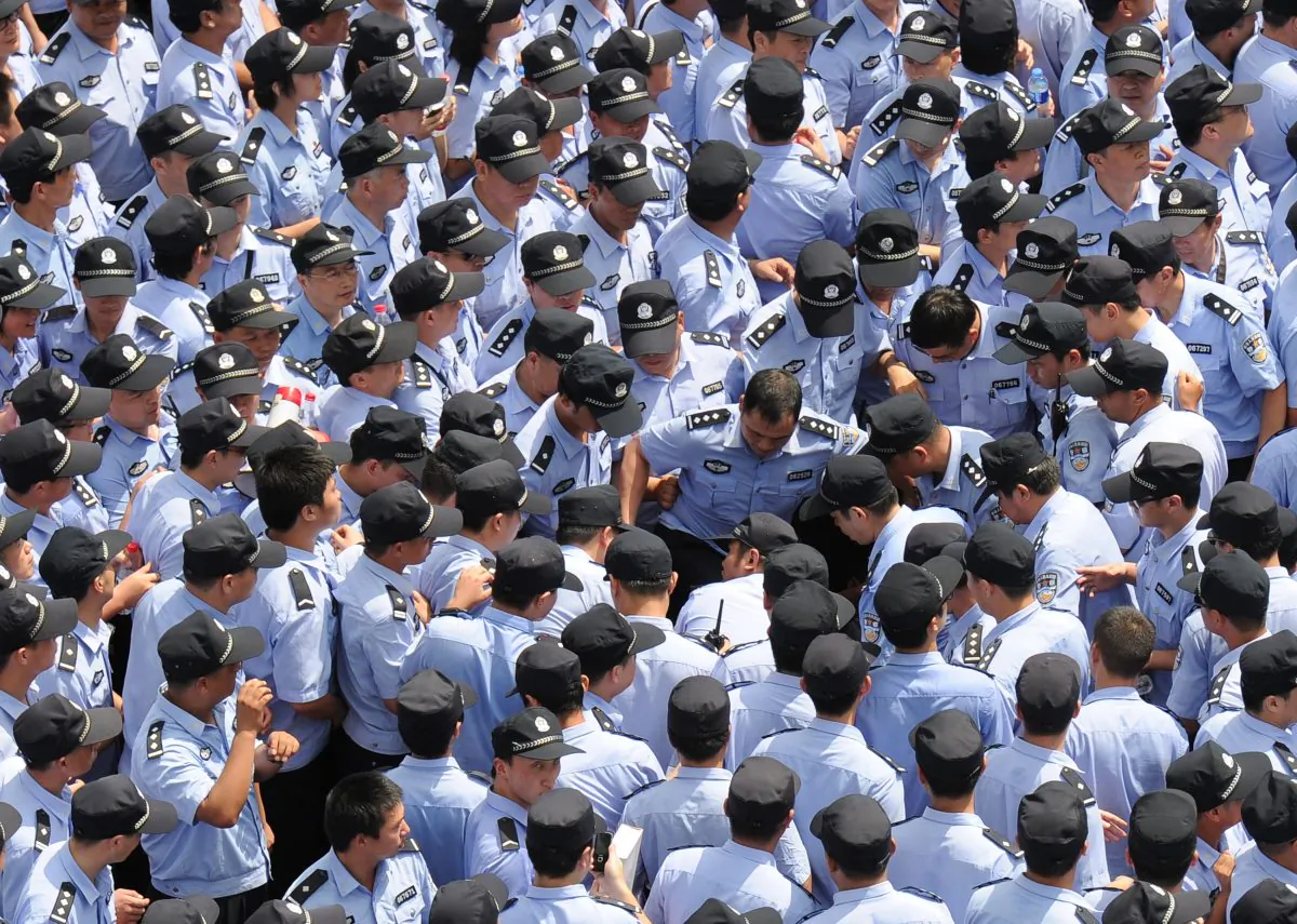 Police swarmed Qidong city, Jiangsu Province to beat demonstrators protesting the alleged pollution of a paper factory in July 2012. “It’s the police’s job to beat people,” a Chinese communist official was recorded in a video that went viral after Sunday.