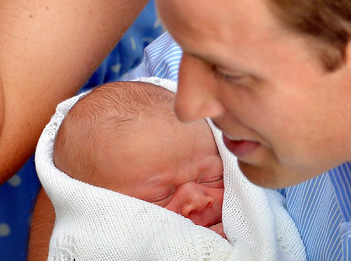 Prince William the Duke of Cambridge holds his new-born baby boy in front of the world's media outside the Lindo Wing of St. Mary's Hospital in London on July 23, 2013. The baby was born on Monday afternoon weighing eight pounds six ounces (3.8 kilogrammes). The baby, titled His Royal Highness, Prince (name) of Cambridge, is directly in line to inherit the throne after Charles, Queen Elizabeth II's eldest son and heir, and his eldest son William. (John Stillwell/AFP/Getty Images)