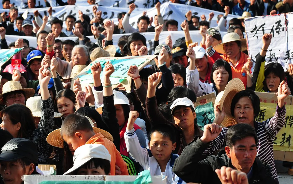 Villagers in Wukan Village, Lufeng County, Guandong Province hold banners and placards to protest local officials' illegal land seizures on Dec. 19, 2011. Local authorities are increasingly worried about mass protests that are organized by grassroots organizations like the village clans in Wukan that mobilized to protest. (STR/AFP/Getty Images)