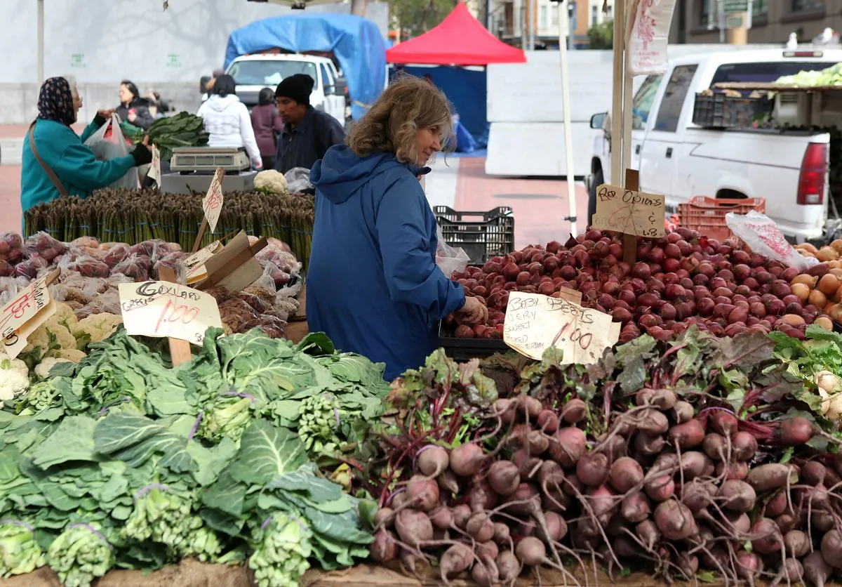 A customer shops for fresh vegetables at a farmers market on March 16, 2011 in this file photo. The desire for sustainable, and healthy alternatives to mass-produced foods is sweeping the nation, a notion of-which Oregon has been immersed in for decades. (Photo by Justin Sullivan/Getty Images)