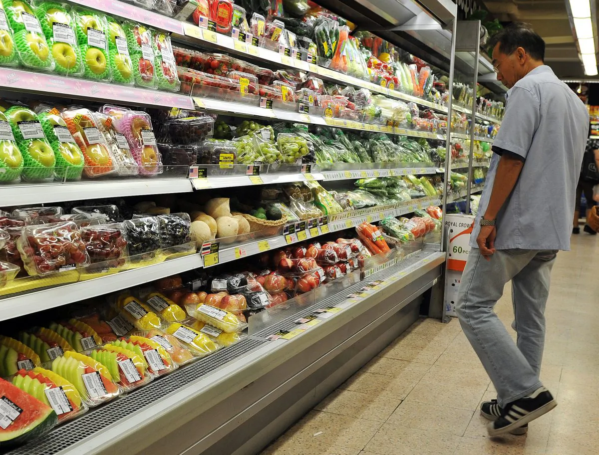 In this file photo a man looks at fresh produce while shopping at a supermarket in Hong Kong on Oct. 3, 2011. The billionaire Li Kai-shing has put his grocery store chain ParknShop up for sale. (Laurent Fievet/AFP/Getty Images) 