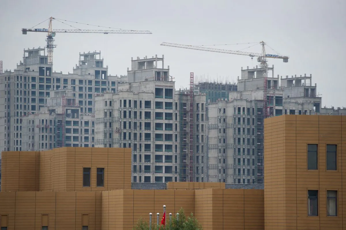 A photo taken on Aug. 18, 2012 shows ongoing construction in the inner Mongolian city of Erdos, in spite of the difficulty the city has had filling office and apartment buildings already built. Recent financial difficulties have caused Erdos, formerly known as a “ghost city” to become known as a “debt city.” (Ed Jones/AFP/GettyImages)