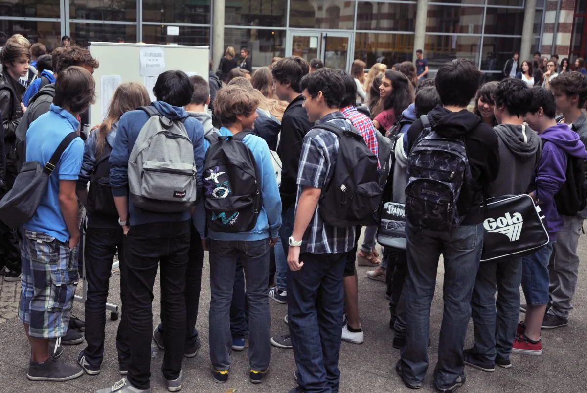 Students gather around before heading into school. The Mayo Clinic estimates nearly half of all school-aged children are bullied at some point. FRANK PERRY/AFP/GettyImages)