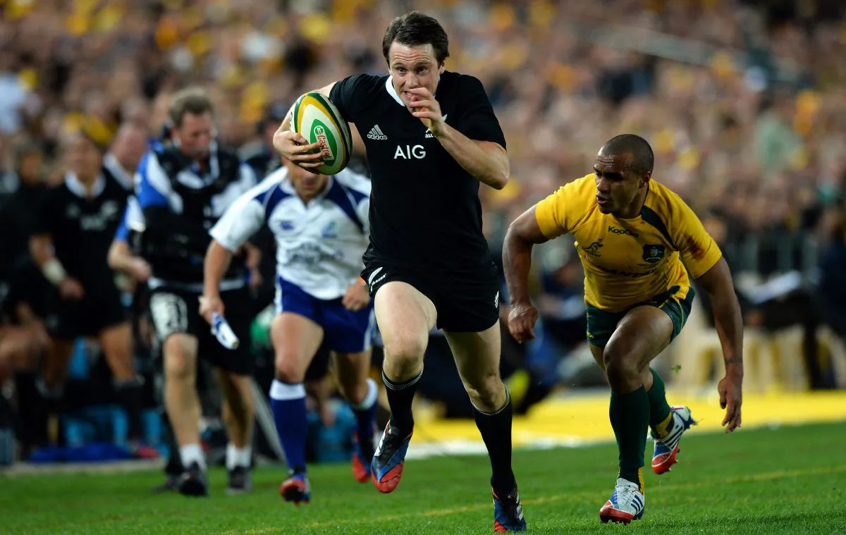 All Black wing Ben Smith evades Will Genia before scoring one of his three during the match against the Wallabies on Saturday Aug 17, 2013. (SAEED KHAN/AFP/Getty Images)