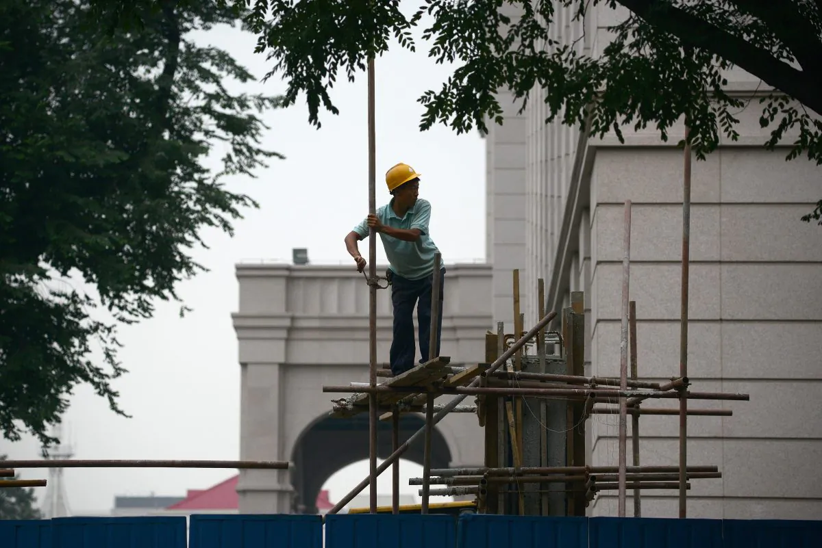 This picture taken on July 11, 2013 shows a Chinese worker putting up the scaffolding at a construction site in Beijing. The Chinese economy could be $1 trillion smaller than thought, according to an economist's number crunching. (WANG ZHAO/AFP/Getty Images)