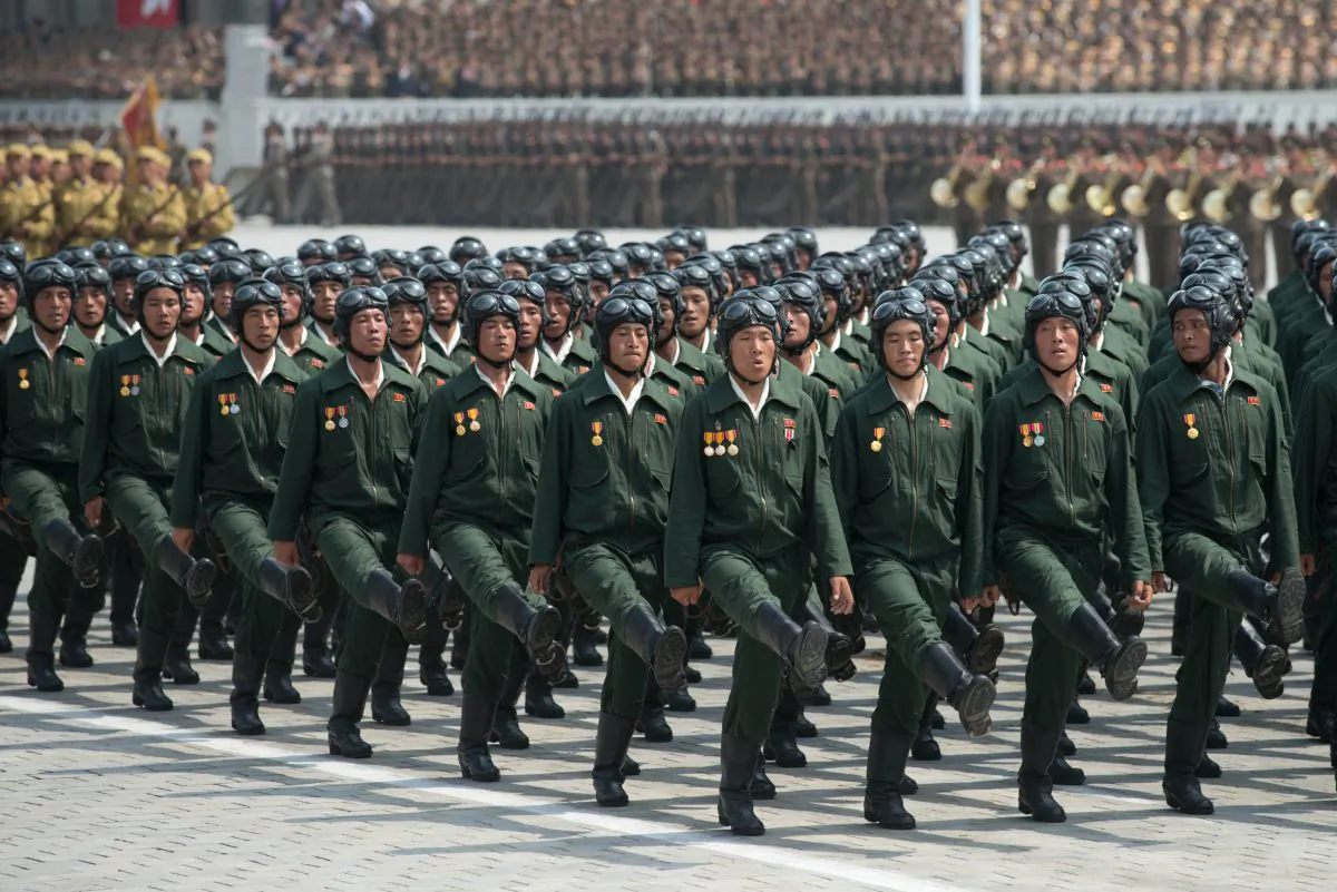 North Korean soldiers march during a military parade past Kim Il-Sung square marking the 60th anniversary of the Korean war armistice in Pyongyang on July 27, 2013. Soldiers marching with backpacks with the symbol for radioactivity on them are said by a Chinese netizen to have been carrying foam boards. (Ed Jones/AFP/Getty Images)