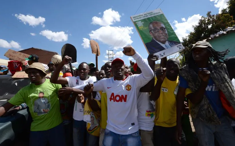 Supporters of Robert Mugabe's ZANU-PF party celebrate his recent election victory in Mbare, Zimbabwe, on Aug. 4. (Alexander Joe/AFP/Getty Images)