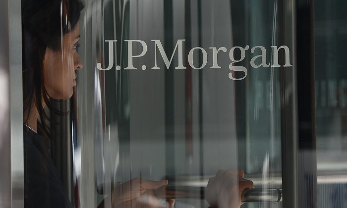 A woman is seen leaving JP Morgan Chase & Company headquarters in New York, on Aug 14, 2013. JPMorgan is just one of the Wall Street banks which employs relatives of CCP officials to get business in China (Emmanual Dunand/AFP/Getty Images)