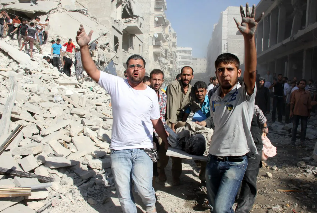 Syrians men evacuate a victim following an air strike by regime forces in the northern city of Aleppo on Aug. 26. Syria's opposition accused pro-regime forces of opening fire at U.N. weapons inspectors on their way to a suspected chemical weapons site outside Damascus in a bid to hinder their investigation. (ABO AL-NUR SADK/AFP/Getty Images)